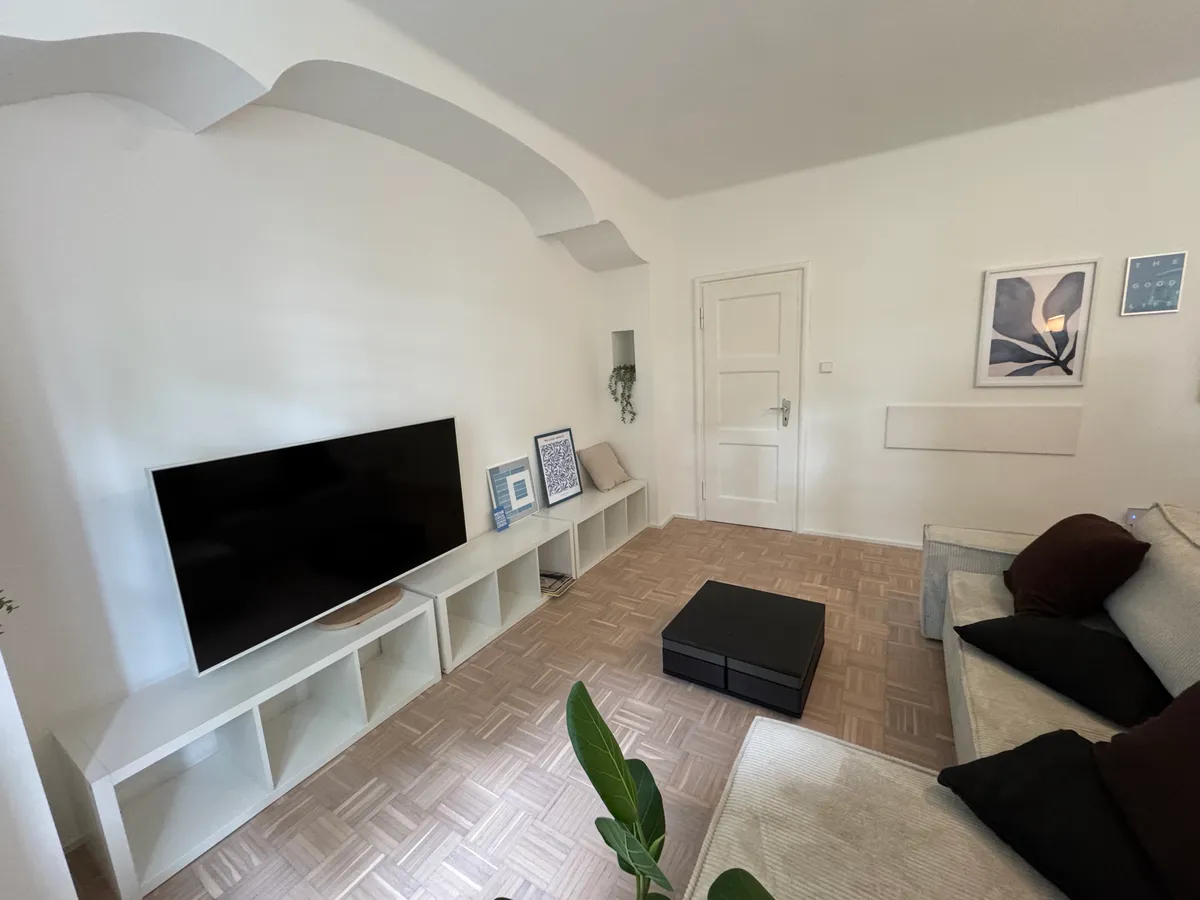 Living area with TV, coffee table and corner sofa