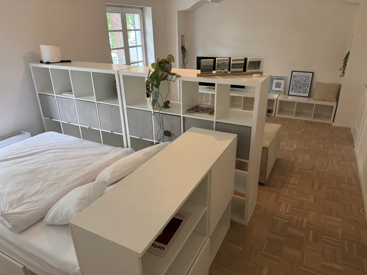 Single bed with pillows and gallery wall