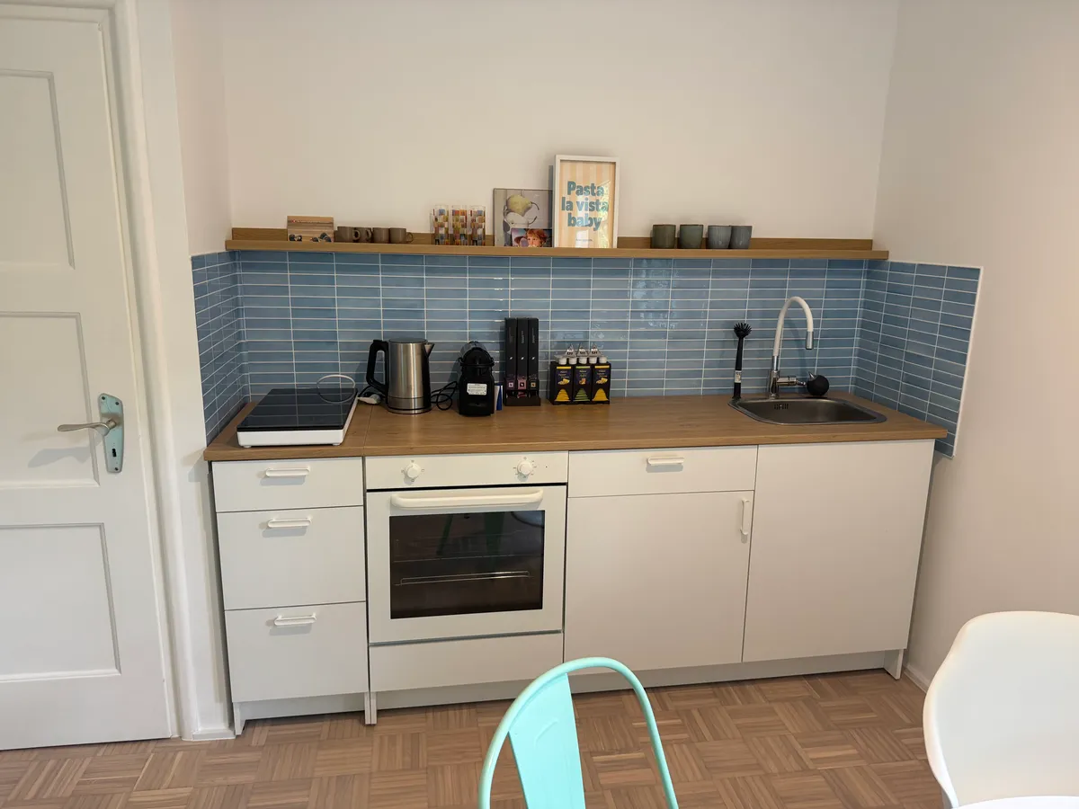 Dining table with retro fridge and mismatched chairs
