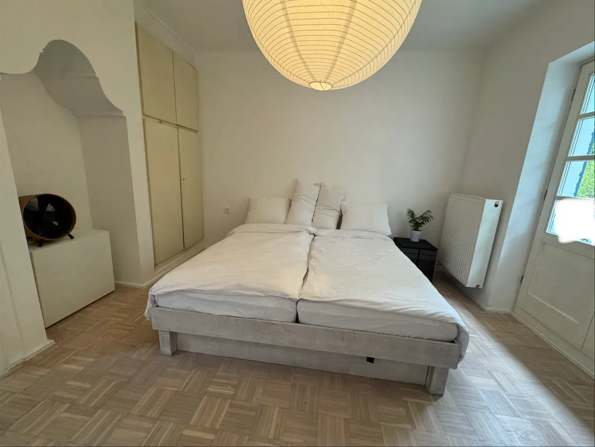 Bedroom with double bed and paper lantern pendant light