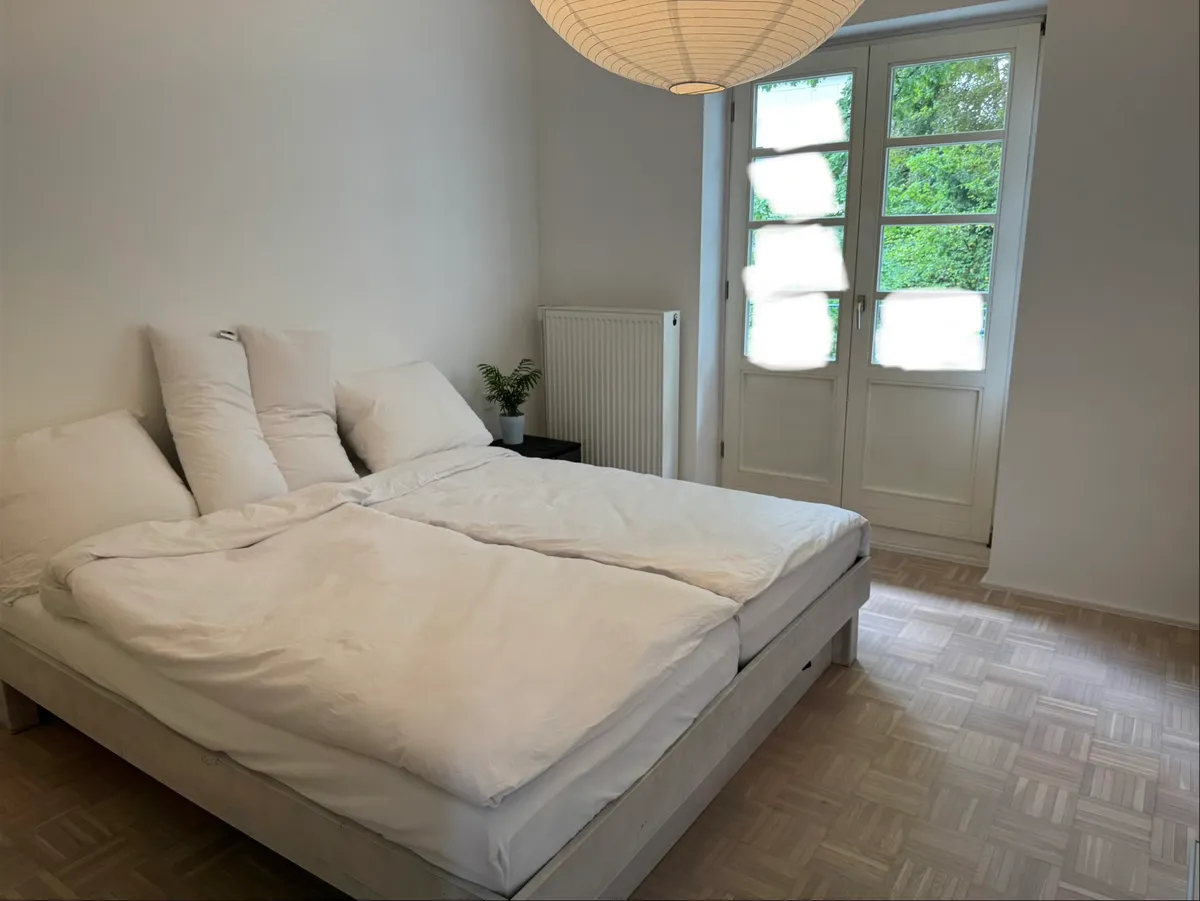 Bedroom with double bed and door to garden balcony